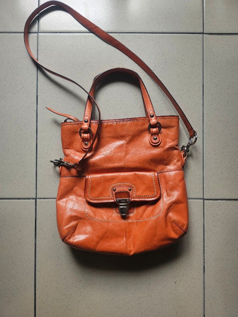 Coach Orange Leather Tote Shoulder Bag (Category: Luxury Bags & Wallets) located in Marikina City. Submitted by charmaine185845 (Listing ID 1465335274, Image 1). Description: - Brand: Coach - Color: Bright orange with contrast white stitching - Material: Soft, slouchy leather - Hardware: Silver-tone with front flap turn-lock closure, rings, and studs - Straps: Dual top carry handles and a detachable long shoulder strap - Interior: Clean setup, id