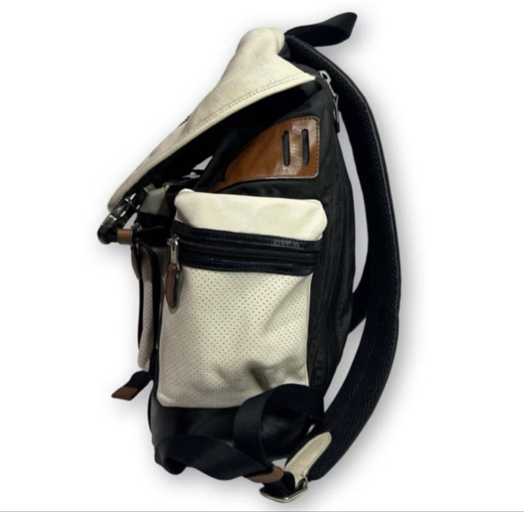 Coach Perforated Leather and Nylon Backpack (Category: Backpacks) located in Digos. Submitted by tindahannimaria (Listing ID 1465280625, Image 3). Description: - Brand: Coach - Material: Black and white perforated leather with nylon panels - Closure: Drawstring under front flap with stylish buckle accents - Pockets: Convenient side zipper pockets - Straps: Top handle and adjustable leather-padded shoulder straps for comfort - Inclusions: Original
