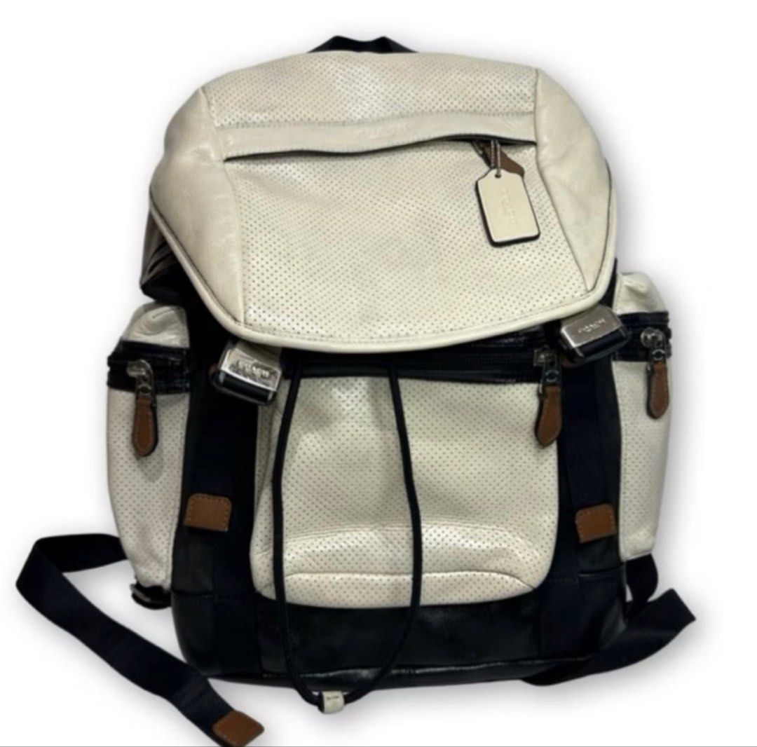 Coach Perforated Leather and Nylon Backpack (Category: Backpacks) located in Digos. Submitted by tindahannimaria (Listing ID 1465280625, Image 1). Description: - Brand: Coach - Material: Black and white perforated leather with nylon panels - Closure: Drawstring under front flap with stylish buckle accents - Pockets: Convenient side zipper pockets - Straps: Top handle and adjustable leather-padded shoulder straps for comfort - Inclusions: Original