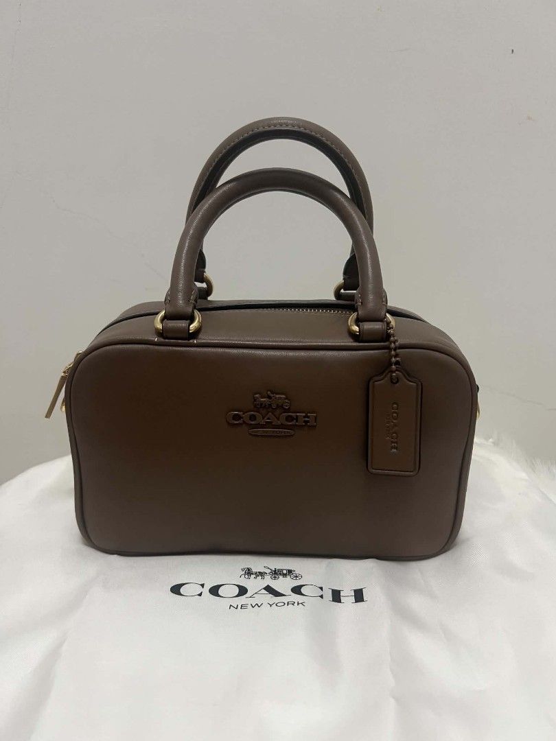 Coach Satchel Sling Bag Dark Stone (Category: Cross-body Bags) located in Paoay. Submitted by rvf1230 (Listing ID 1465189296, Image 3). Description: - Brand: Authentic Coach - Style: Studio Carryall - Color: Dark Stone - Material: Premium Leather - Hardware: Gold-tone - Closure: Secure zip-top - Inclusions: Original white dust bag, hanging leather logo tag, care card, and price tag - Condition: Clean exterior and interior - Size: Great everyday s