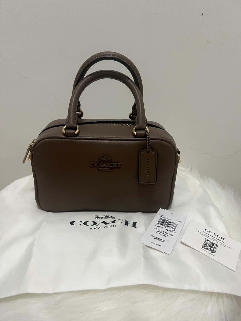 Coach Satchel Sling Bag Dark Stone (Category: Cross-body Bags) located in Paoay. Submitted by rvf1230 (Listing ID 1465189296, Image 1). Description: - Brand: Authentic Coach - Style: Studio Carryall - Color: Dark Stone - Material: Premium Leather - Hardware: Gold-tone - Closure: Secure zip-top - Inclusions: Original white dust bag, hanging leather logo tag, care card, and price tag - Condition: Clean exterior and interior - Size: Great everyday s