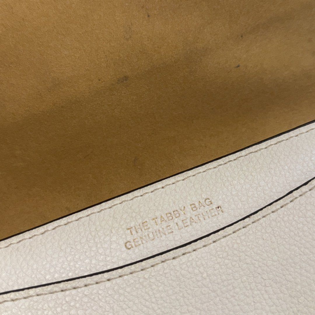 Coach Tabby Bag White Leather (Category: Luxury Bags & Wallets) located in Manila. Submitted by wisecloud_1b4b3c (Listing ID 1465266868, Image 2). Description: - Brand: Coach - Style: Tabby Handbag (Style No. CH857) - Material: Genuine white leather - Hardware: Brass tone with signature C clasp front closure - Design: Structured rectangular shape with top handle - Interior: Includes zippered compartment and official Coach creed patch - Condition: