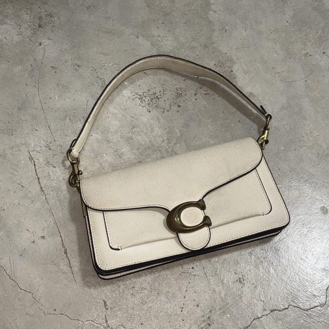 Coach Tabby Bag White Leather (Category: Luxury Bags & Wallets) located in Manila. Submitted by wisecloud_1b4b3c (Listing ID 1465266868, Image 1). Description: - Brand: Coach - Style: Tabby Handbag (Style No. CH857) - Material: Genuine white leather - Hardware: Brass tone with signature C clasp front closure - Design: Structured rectangular shape with top handle - Interior: Includes zippered compartment and official Coach creed patch - Condition: