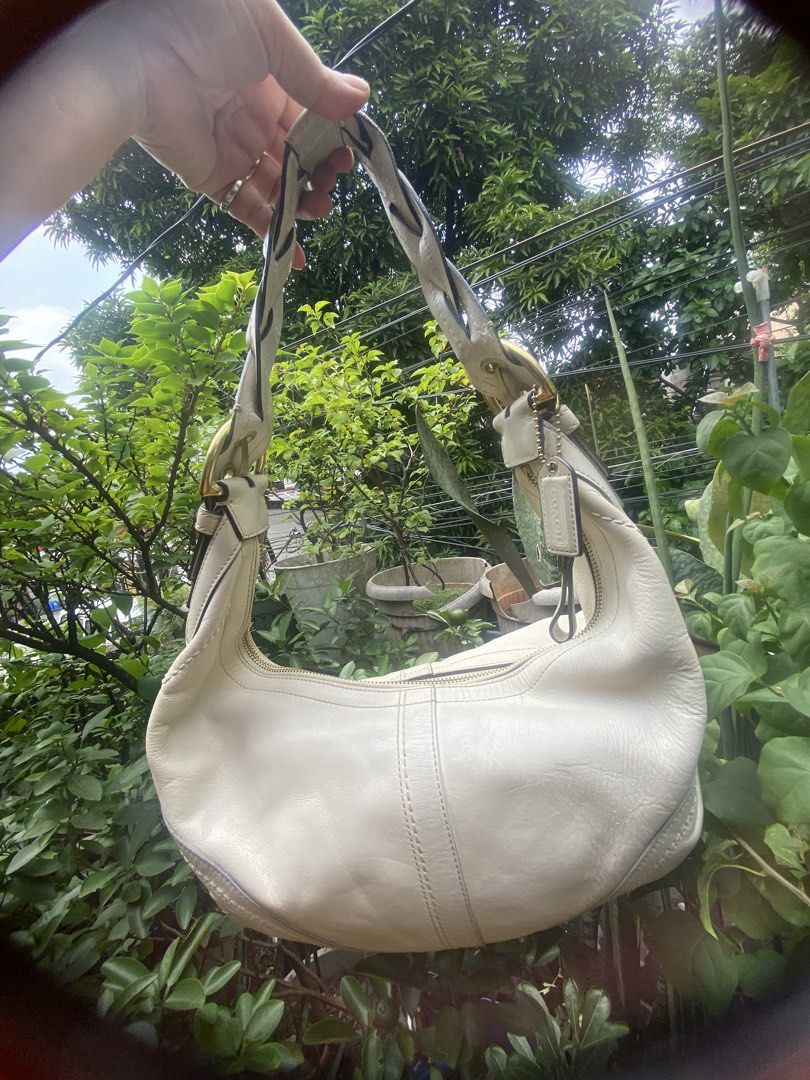 Coach White Leather Shoulder Bag (Category: Luxury Bags & Wallets) located in Rizal. Submitted by rosemarievillaluna176 (Listing ID 1465197953, Image 2). Description: - Authentic Coach shoulder bag in a versatile creamy off-white leather - Stylish braided strap detail with classy brass hardware - Secure zipper top closure to keep your essentials safe - Spacious interior with a clean silhouette and structured bottom stitching - Comes with the icon