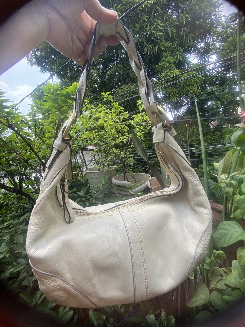 Coach White Leather Shoulder Bag (Category: Luxury Bags & Wallets) located in Rizal. Submitted by rosemarievillaluna176 (Listing ID 1465197953, Image 1). Description: - Authentic Coach shoulder bag in a versatile creamy off-white leather - Stylish braided strap detail with classy brass hardware - Secure zipper top closure to keep your essentials safe - Spacious interior with a clean silhouette and structured bottom stitching - Comes with the icon