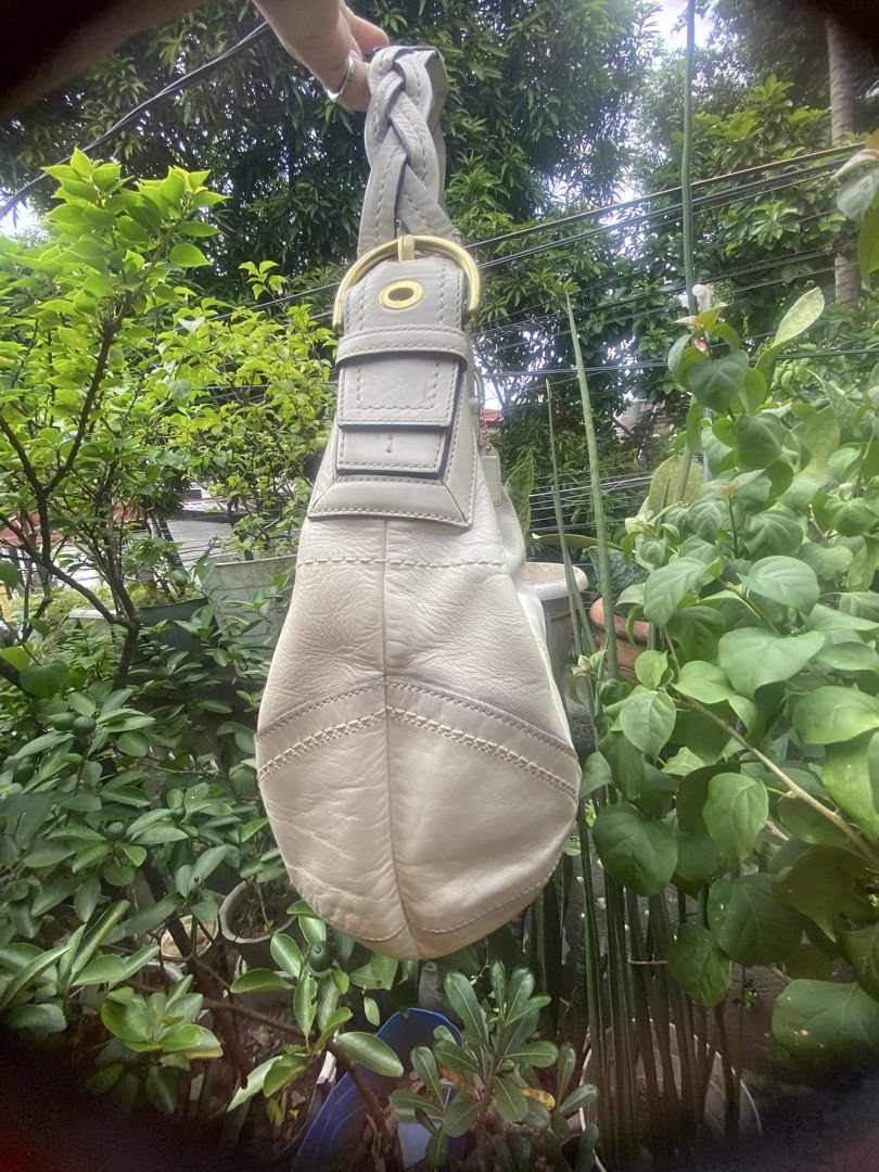 Coach White Leather Shoulder Bag (Category: Luxury Bags & Wallets) located in Rizal. Submitted by rosemarievillaluna176 (Listing ID 1465197953, Image 3). Description: - Authentic Coach shoulder bag in a versatile creamy off-white leather - Stylish braided strap detail with classy brass hardware - Secure zipper top closure to keep your essentials safe - Spacious interior with a clean silhouette and structured bottom stitching - Comes with the icon