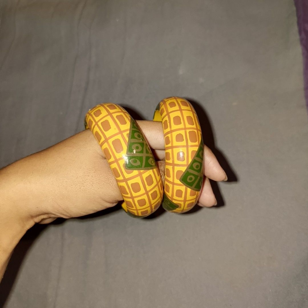 Colorful striped and patterned wooden bangles stack (Category: Bracelets) located in Bulacan. Submitted by snumxxx (Listing ID 1465277043, Image 3). Description: - Variety of thick wooden bangles in vibrant colors and unique patterns - Designs include solid red, solid teal blue, yellow with green triangles, and striped pastel rainbow - Smooth polished finish for comfortable wear - Wear individually for a pop of color or stack together for a bold 