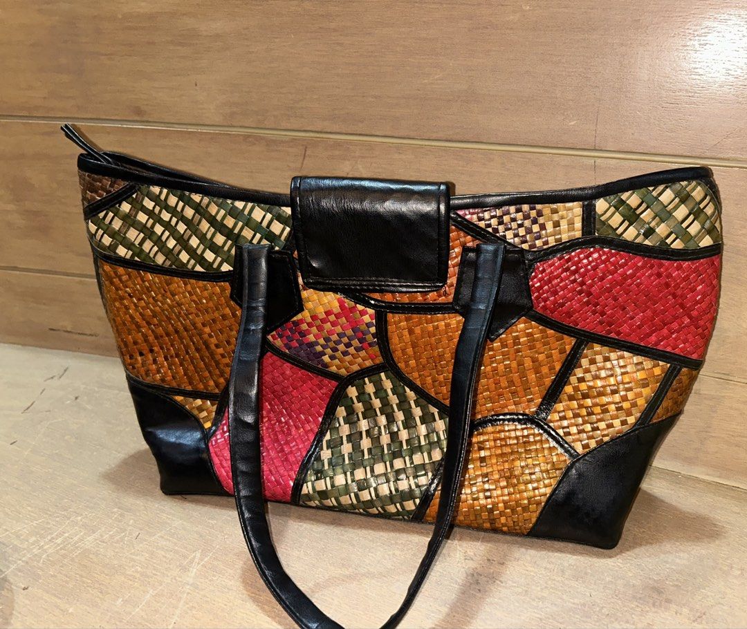 Colorful Woven Patchwork Tote Bag with Black Straps (Category: Tote Bags) located in Makati City. Submitted by riad_88 (Listing ID 1465318127, Image 2). Description: - Vibrant multicolor woven straw tote bag with striking red, green, brown, and tan patterns - Secure top zip closure and stylish black leather-look front flap - Comfortable black leather-look shoulder handles - Roomy interior lined with solid brown fabric - Convenient built-in slip p