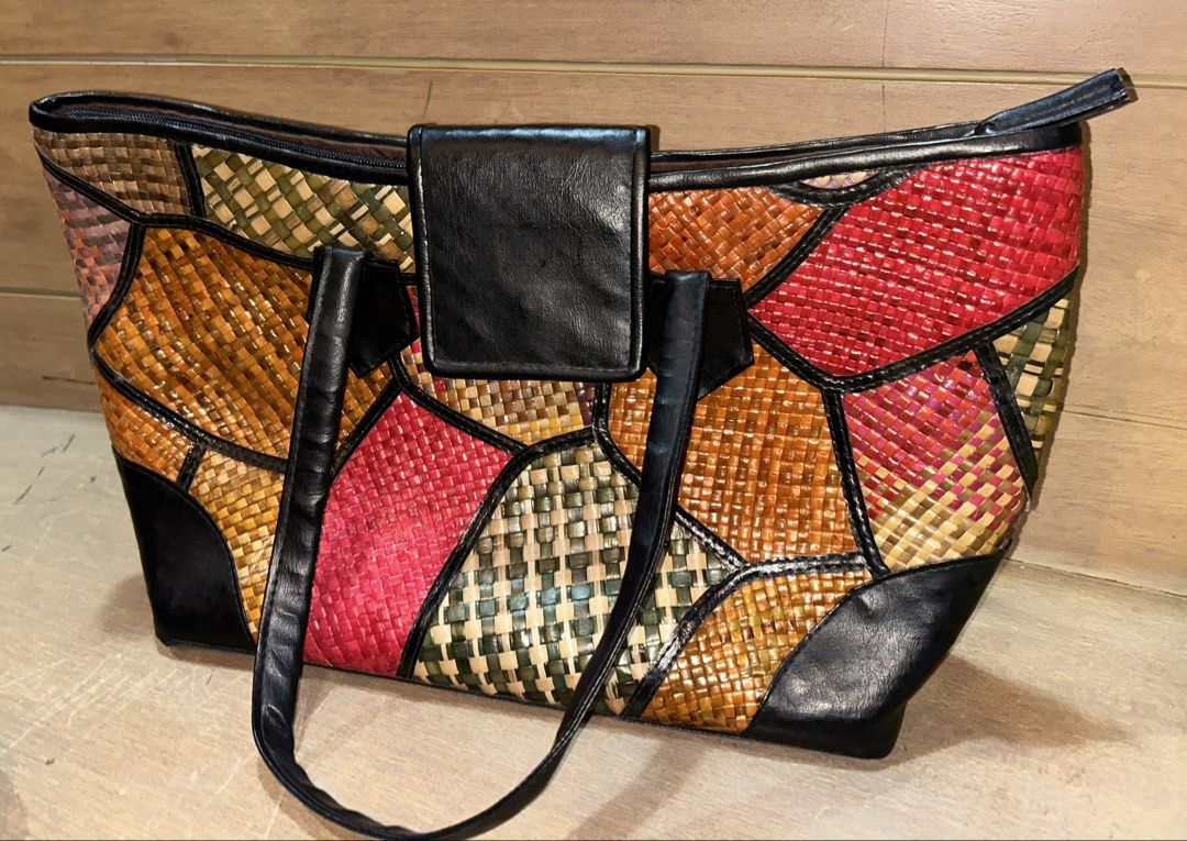 Colorful Woven Patchwork Tote Bag with Black Straps (Category: Tote Bags) located in Makati City. Submitted by riad_88 (Listing ID 1465318127, Image 1). Description: - Vibrant multicolor woven straw tote bag with striking red, green, brown, and tan patterns - Secure top zip closure and stylish black leather-look front flap - Comfortable black leather-look shoulder handles - Roomy interior lined with solid brown fabric - Convenient built-in slip p
