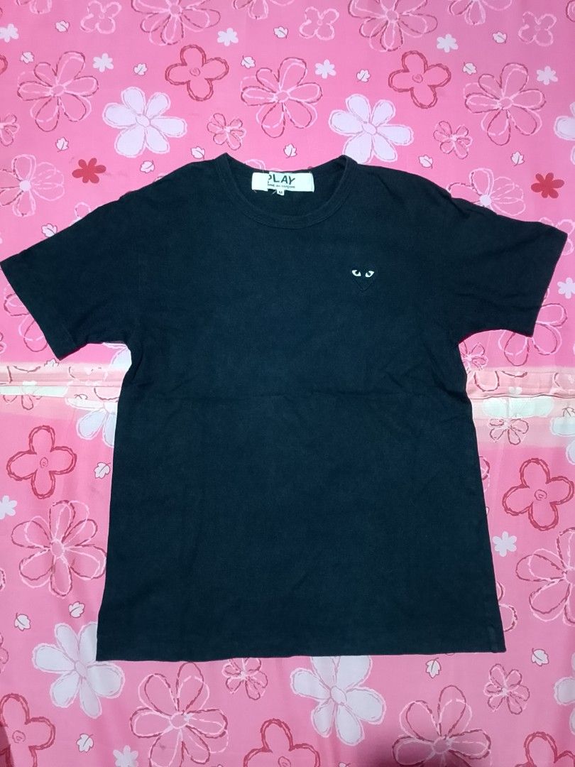 COMME des GARÇONS PLAY Black Heart Tee Size M (Category: Shirts) located in Iloilo. Submitted by janillthrifted (Listing ID 1465313259, Image 2). Description: - Brand: COMME des GARÇONS PLAY - Color: Black - Size: Medium (Tag attached) - Material: 100% Cotton, Made in Japan - Features: Iconic embroidered red heart logo, classic crew neck - Details: Original neck label and care tag included (Product Code: AZ-T064) - Condition: Excellent, well-main
