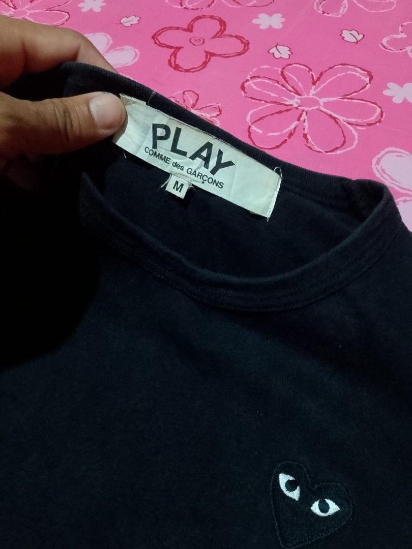COMME des GARÇONS PLAY Black Heart Tee Size M (Category: Shirts) located in Iloilo. Submitted by janillthrifted (Listing ID 1465313259, Image 3). Description: - Brand: COMME des GARÇONS PLAY - Color: Black - Size: Medium (Tag attached) - Material: 100% Cotton, Made in Japan - Features: Iconic embroidered red heart logo, classic crew neck - Details: Original neck label and care tag included (Product Code: AZ-T064) - Condition: Excellent, well-main