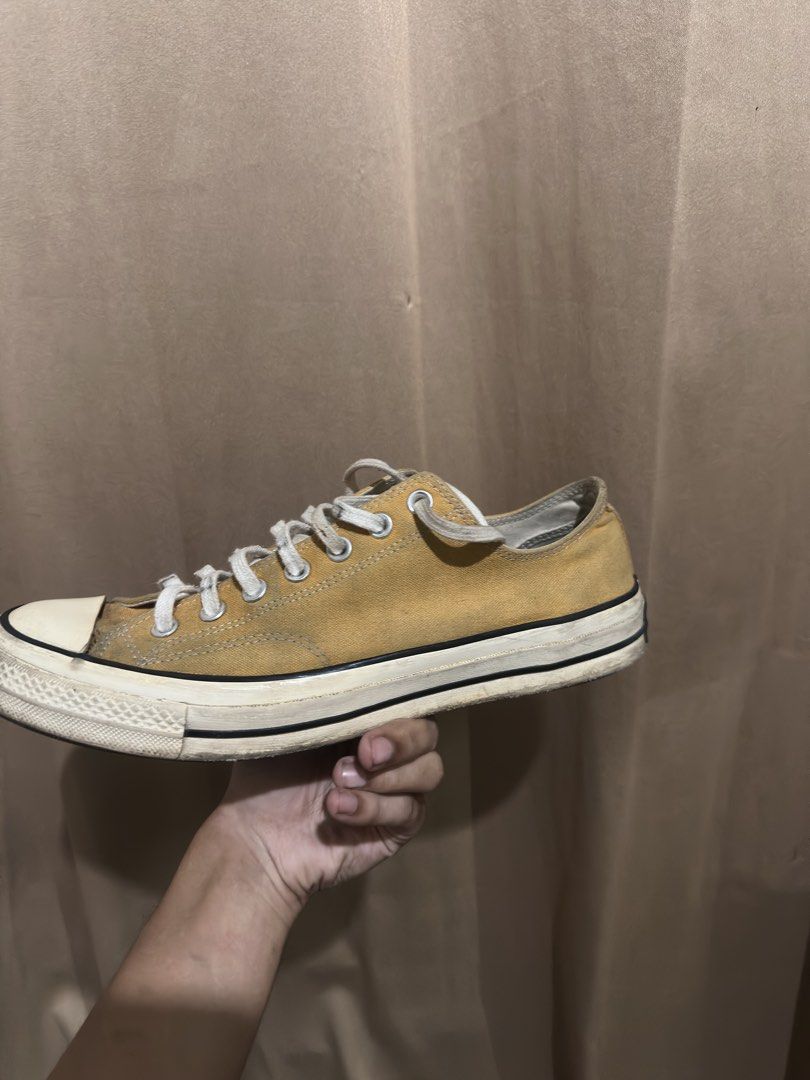 Converse Chuck 70 Low Top Sunflower Yellow (Category: Sneakers) located in Quezon City. Submitted by bebe0827 (Listing ID 1465300665, Image 2). Description: - Brand: Converse - Model: Chuck 70 Low Top - Color: Sunflower Yellow - Features: Classic rubber toe cap, foxing tape, metal eyelets, includes white laces - Condition: Pre-owned with visible signs of wear and dirt marks along the midsole and upper canvas - Perfect for daily casual wear.