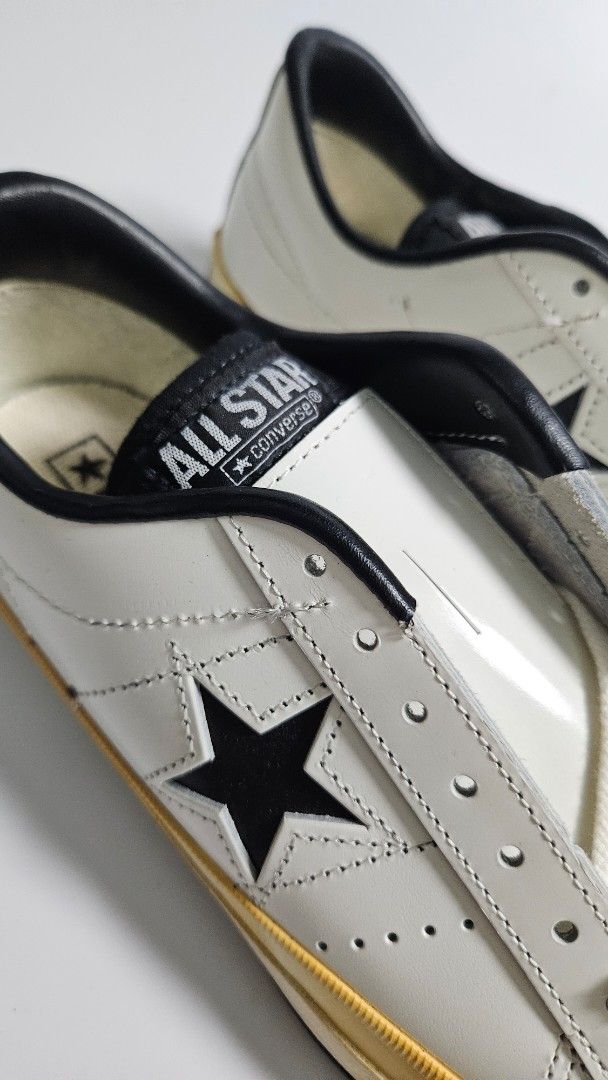 Converse One Star Vintage Leather White Black (Category: Sneakers) located in Alfonso. Submitted by jbcamet (Listing ID 1465240281, Image 2). Description: - Brand: Converse One Star - Color: White leather with black star and trim - Size: 7 - Condition: Brand new, never worn outside, pristine soles - Inclusions: Original tag attached to laces - Sole: Off-white vulcanized midsole with dark brown rubber outsole.