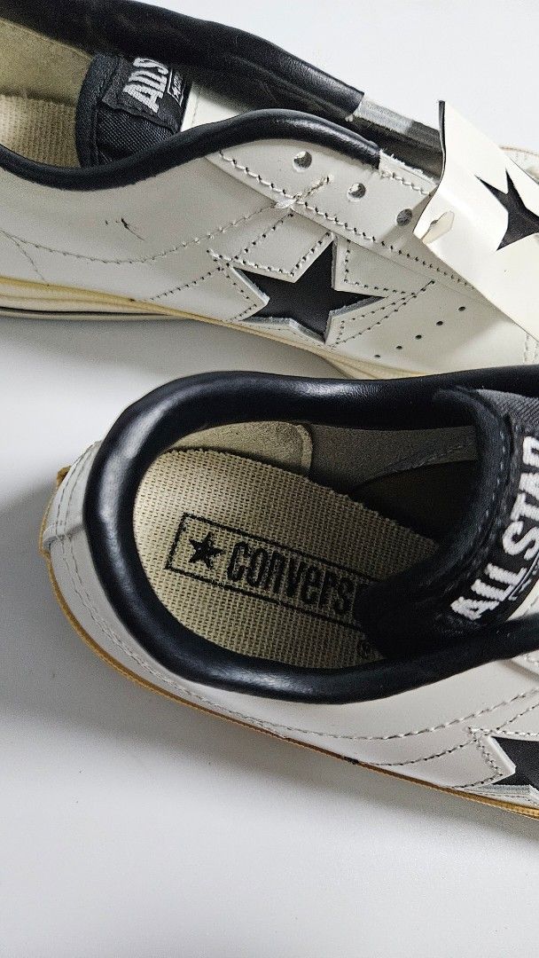 Converse One Star Vintage Leather White Black (Category: Sneakers) located in Alfonso. Submitted by jbcamet (Listing ID 1465240281, Image 3). Description: - Brand: Converse One Star - Color: White leather with black star and trim - Size: 7 - Condition: Brand new, never worn outside, pristine soles - Inclusions: Original tag attached to laces - Sole: Off-white vulcanized midsole with dark brown rubber outsole.