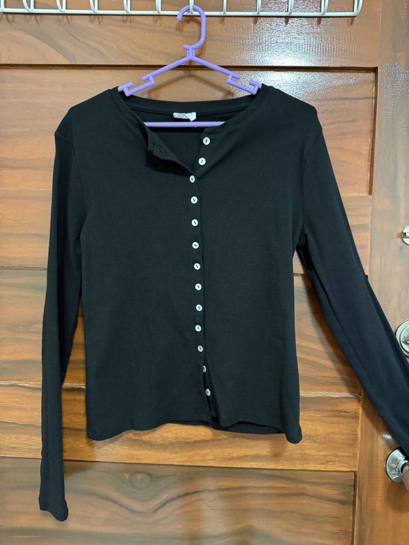 Cotton On Black Button-Down Long Sleeve Top (Category: Longsleeves) located in Quezon City. Submitted by artemis23 (Listing ID 1465380354, Image 1). Description: - Brand: Cotton On - Size: Medium - Color: Black - Material: Soft, stretchy knit fabric - Details: Button-down front with light-colored buttons, classic crew neckline - Condition: Worn 2x great shape - Style Tip: Easy to pair with jeans or skirts for daily casual wear .
