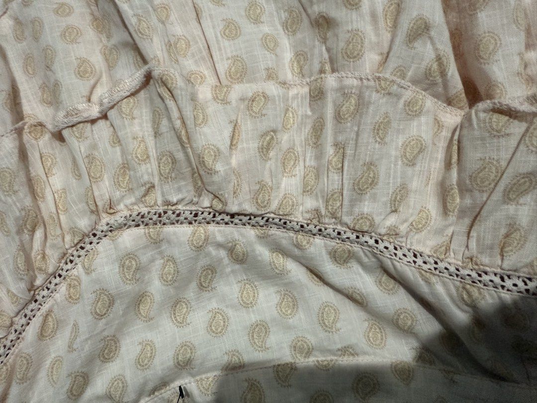 Cotton On Ruffle Mini Skirt (Category: Skirts) located in Mandaluyong City. Submitted by whitemoveout (Listing ID 1465326354, Image 3). Description: - Brand: Cotton On - Style: Tiered ruffle mini skirt with crochet lace trim - Design: All-over paisley print in light pink - Closure: Convenient side zipper - Size: AU 10 / EU 38 / US 6 - Material: Lightweight, made in India - Condition: Great for casual sunny days out.