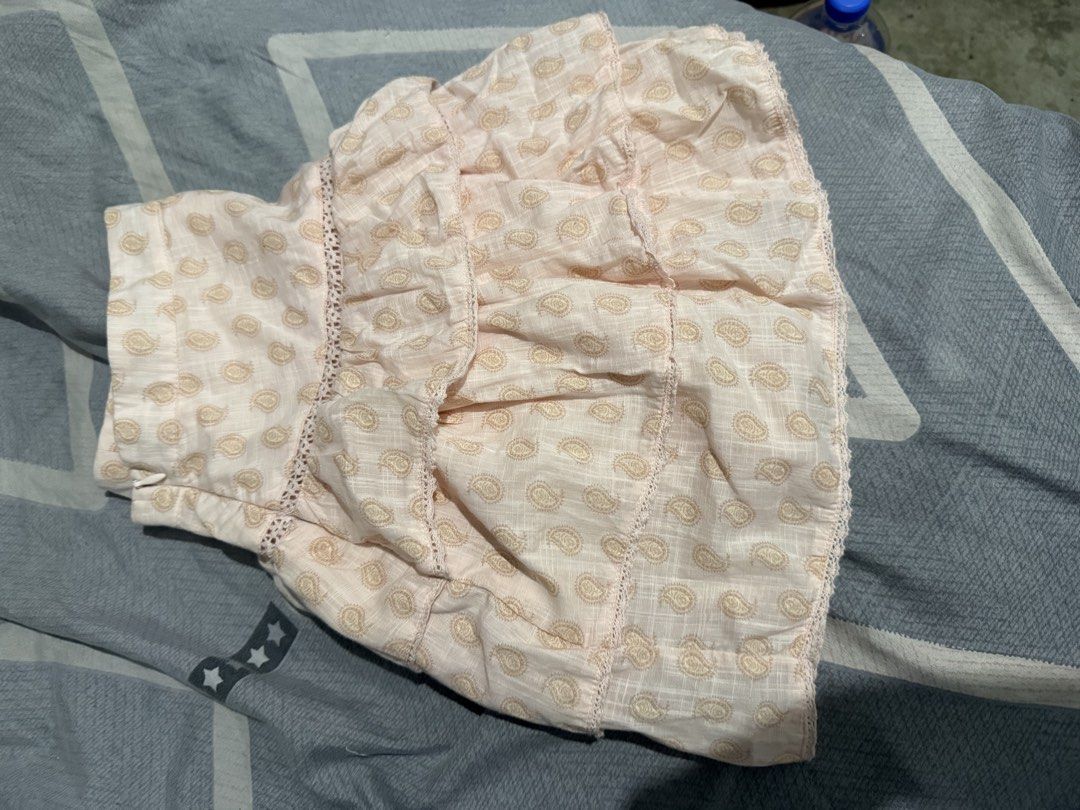 Cotton On Ruffle Mini Skirt (Category: Skirts) located in Mandaluyong City. Submitted by whitemoveout (Listing ID 1465326354, Image 1). Description: - Brand: Cotton On - Style: Tiered ruffle mini skirt with crochet lace trim - Design: All-over paisley print in light pink - Closure: Convenient side zipper - Size: AU 10 / EU 38 / US 6 - Material: Lightweight, made in India - Condition: Great for casual sunny days out.