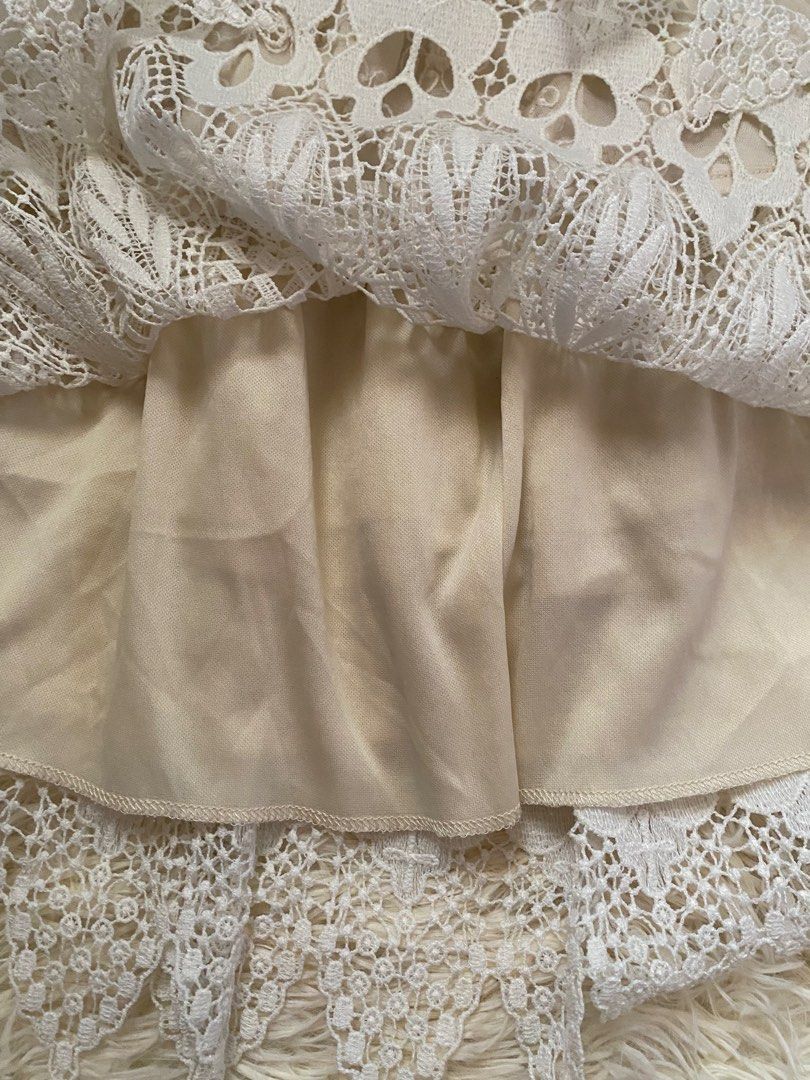 Cream boho lace layered mini skirt (Category: Skirts) located in Guagua. Submitted by zenn_vi (Listing ID 1465273335, Image 3). Description: - Color: Cream - Style: Mini skirt with a comfortable stretchy elastic waistband - Design: Sheer floral embroidered fabric on the top tier - Details: Heavy crochet lace pattern on the lower half with a chic scalloped hem - Lining: Fully lined underneath for coverage.