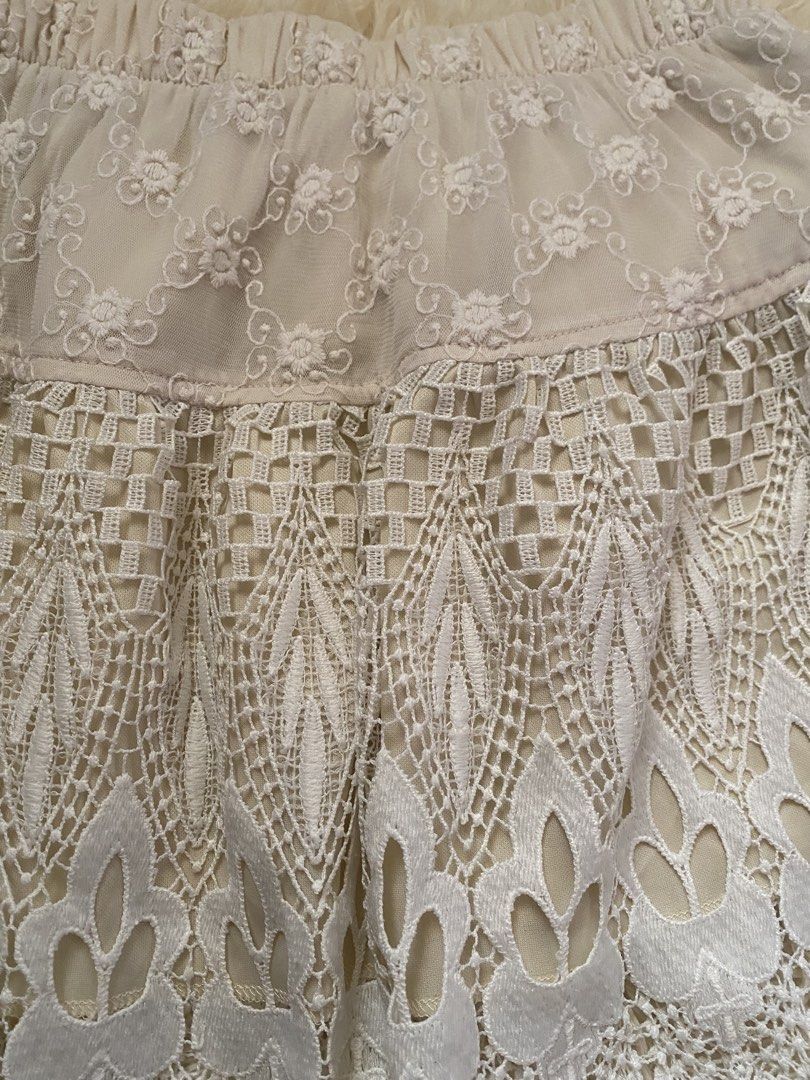 Cream boho lace layered mini skirt (Category: Skirts) located in Guagua. Submitted by zenn_vi (Listing ID 1465273335, Image 2). Description: - Color: Cream - Style: Mini skirt with a comfortable stretchy elastic waistband - Design: Sheer floral embroidered fabric on the top tier - Details: Heavy crochet lace pattern on the lower half with a chic scalloped hem - Lining: Fully lined underneath for coverage.