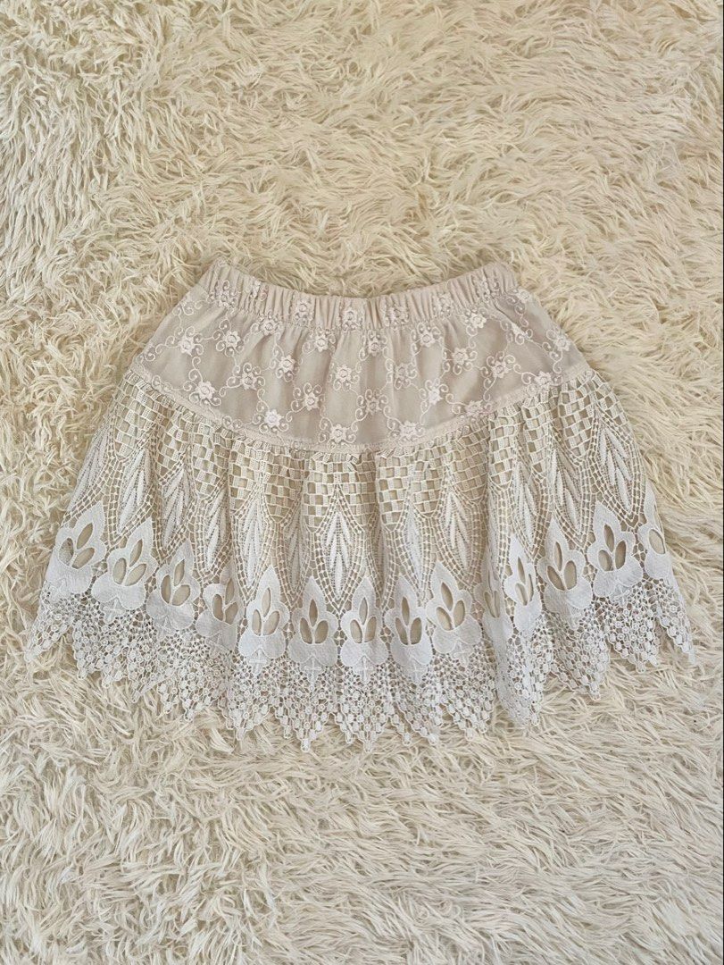 Cream boho lace layered mini skirt (Category: Skirts) located in Guagua. Submitted by zenn_vi (Listing ID 1465273335, Image 1). Description: - Color: Cream - Style: Mini skirt with a comfortable stretchy elastic waistband - Design: Sheer floral embroidered fabric on the top tier - Details: Heavy crochet lace pattern on the lower half with a chic scalloped hem - Lining: Fully lined underneath for coverage.