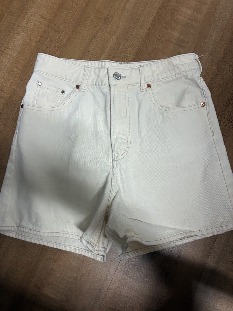 Cream denim high-waisted Bermuda shorts (Category: Shorts) located in Quezon City. Submitted by habits.mnl (Listing ID 1465289746, Image 1). Description: - Color: Off-white - Waist: High-rise - Material: Sturdy cotton fabric - Details: Classic five-pocket style, silver button closure, copper rivets, and clean-finished hems - Fit: Versatile neutral piece, great for warm weather outfits.