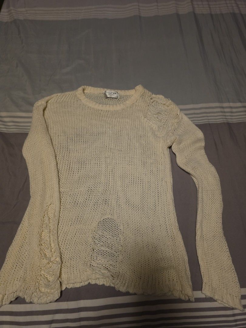 Cream Distressed Long Sleeve Knit Sweater (Category: Longsleeves) located in Manila. Submitted by cher0918 (Listing ID 1465273991, Image 1). Description: - Color: Cream - Style: Open knit, relaxed fit, lightweight with great stretch - Features: Distressed detailing on the right shoulder and lower front, round neckline - Perfect for: Layering during cooler weather - Condition: Excellent (inner collar label intact).