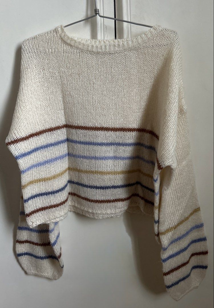 Cream Striped Oversized Knit Sweater (Category: Longsleeves) located in Manila. Submitted by randomstuffiown (Listing ID 1465353665, Image 1). Description: - Color: Cream with colorful horizontal stripes - Material: Soft open knit fabric - Fit: Relaxed fit with long sleeves - Details: Ribbed crew neck collar and hem - Styling: Easy to throw on over jeans or skirts for cooler weather.