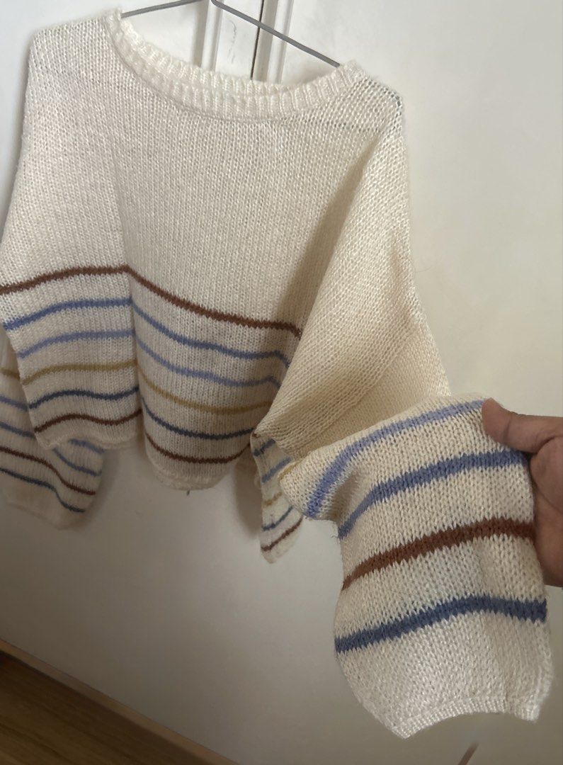Cream Striped Oversized Knit Sweater (Category: Longsleeves) located in Manila. Submitted by randomstuffiown (Listing ID 1465353665, Image 2). Description: - Color: Cream with colorful horizontal stripes - Material: Soft open knit fabric - Fit: Relaxed fit with long sleeves - Details: Ribbed crew neck collar and hem - Styling: Easy to throw on over jeans or skirts for cooler weather.