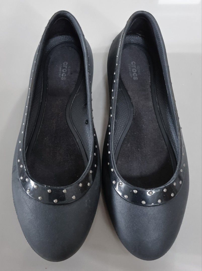 Crocs Studded Black Flat Shoes (Category: Flats & Sandals) located in Danao, Cebu. Submitted by CaxeCart (Listing ID 1465226044, Image 1). Description: - Color: Black - Style: Slip-on flats with iconic comfort insoles - Details: Glossy collar trim with all-around silver studs and ventilation holes on the inner sides - Condition: Minor signs of wear on the soles and footbeds - Ideal for: Everyday casual wear.