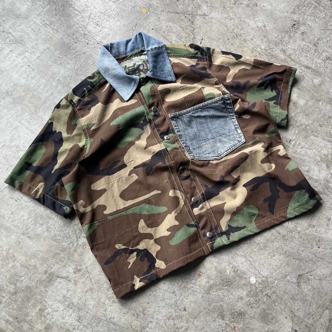 Custom Upcycled Camo and Denim Short Sleeve Button Up (Category: Tshirts & Polo Shirts ) located in Bulacan. Submitted by afterlife___atelier (Listing ID 1465257548, Image 2). Description: Size:l Good for height:5’5-5’8 Model height: 5’5 Condition:5/5 Material:Ripstop from army coat & Denim -Dimensions Lenght:23” Width:23” 🚚Courier:J&T / Lalamove 💸Payment:Paymaya/Gcash 📍Location:Fairview QC Please see description and double check pictures that