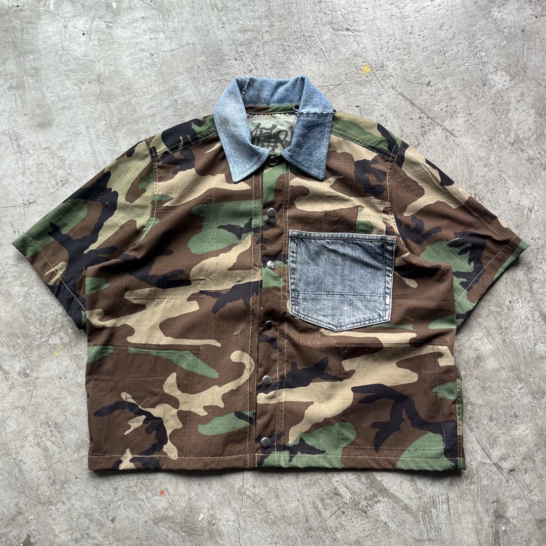 Custom Upcycled Camo and Denim Short Sleeve Button Up (Category: Tshirts & Polo Shirts ) located in Bulacan. Submitted by afterlife___atelier (Listing ID 1465257548, Image 1). Description: Size:l Good for height:5’5-5’8 Model height: 5’5 Condition:5/5 Material:Ripstop from army coat & Denim -Dimensions Lenght:23” Width:23” 🚚Courier:J&T / Lalamove 💸Payment:Paymaya/Gcash 📍Location:Fairview QC Please see description and double check pictures that