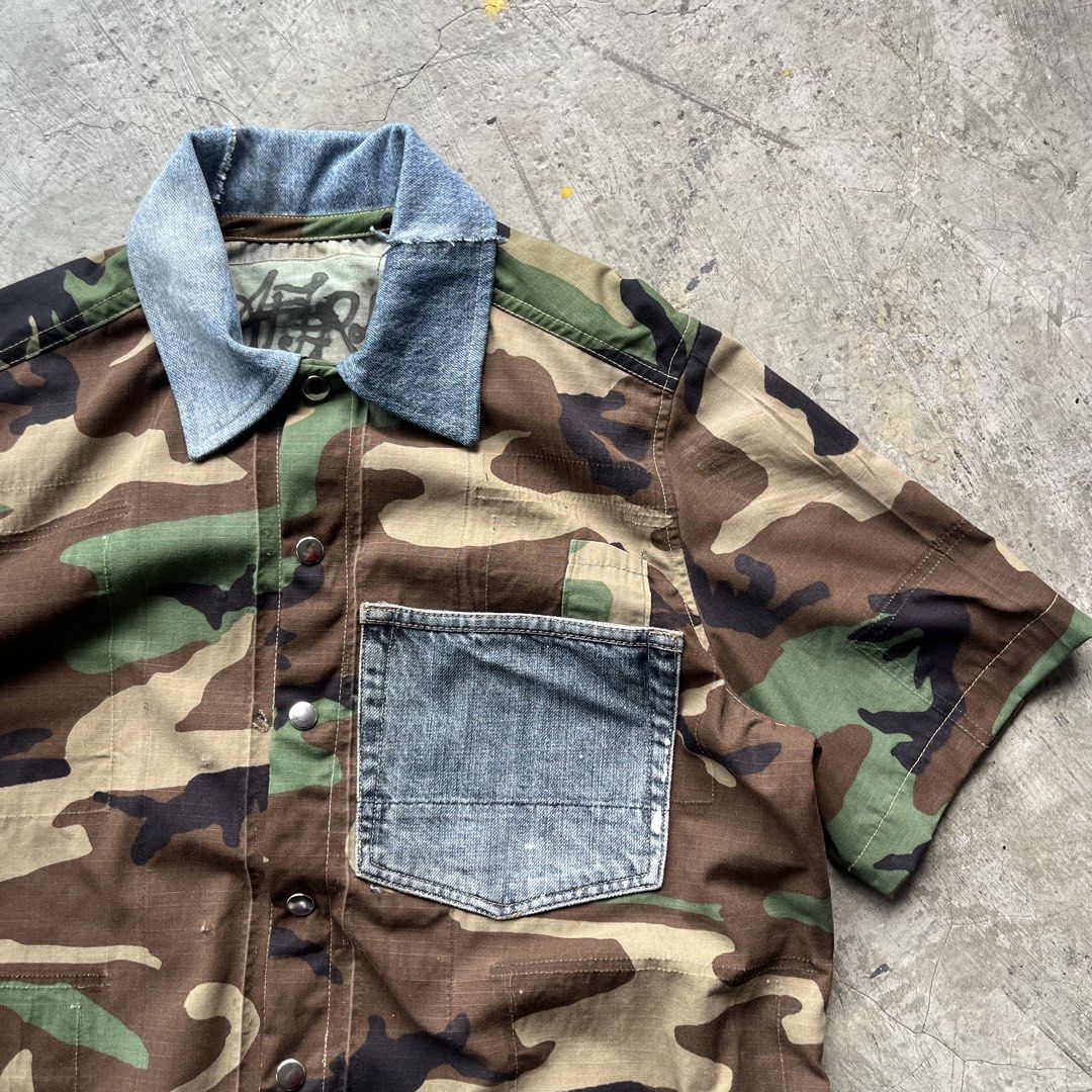Custom Upcycled Camo and Denim Short Sleeve Button Up (Category: Tshirts & Polo Shirts ) located in Bulacan. Submitted by afterlife___atelier (Listing ID 1465257548, Image 3). Description: Size:l Good for height:5’5-5’8 Model height: 5’5 Condition:5/5 Material:Ripstop from army coat & Denim -Dimensions Lenght:23” Width:23” 🚚Courier:J&T / Lalamove 💸Payment:Paymaya/Gcash 📍Location:Fairview QC Please see description and double check pictures that