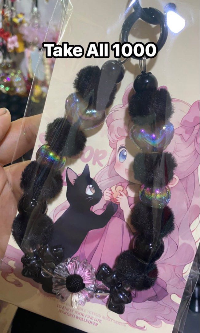 Cute Beaded Keychain with Pom Pom (Category: Charms) located in Tanauan. Submitted by mariacraftcorner (Listing ID 1465308144, Image 1). Description: - Adorable keychain featuring furry pom poms, shiny iridescent hearts, and flower charms - Includes a backing card with cute anime girl and black cat artwork - Available in 4 lovely colors: Black, Purple, Pink, and Light Blue - Price: ₱1,000 each - Take-all deal option available—message us for detai
