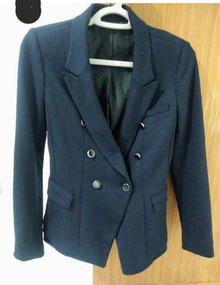 Dark blue double-breasted blazer (Category: Coats, Jackets and Outerwear) located in Marikina City. Submitted by newowners2025 (Listing ID 1465219312, Image 2). Description: Size: Small Shoulder: 16 in Length: 22 in - Thick fabric - With lining - No flaws/issues (still good as brand new) - double-breasted - Tailored fit - Smooth fabric - Two front pockets - Perfect for corporate/office/formal events .