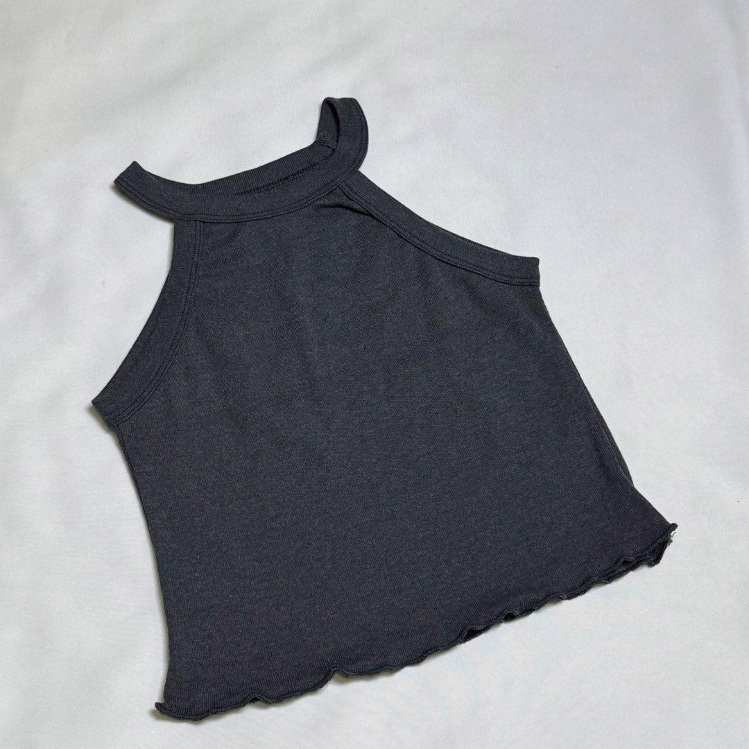 Dark Grey Ribbed Halter Neck Crop Top (Category: Sleeveless) located in Santa Rosa. Submitted by kym_11 (Listing ID 1465333612, Image 1). Description: - Color: Dark grey - Style: Halter neck crop top with high neckline and cut-in shoulders - Material: Stretchy ribbed fabric - Detail: Lettuce hem finish - Fit: Great for pairing with high-waisted jeans or skirts - Condition: Brand new / Excellent (modify as needed).