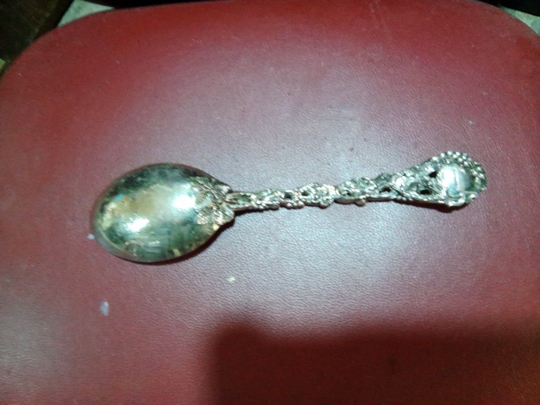 Decorative vintage silver plated spoon with ornate handle (Category: Dinnerware & Cutlery) located in Davao. Submitted by bravemoon_556cd5 (Listing ID 1465241806, Image 1). Description: - Vintage silver spoon with intricate grape and vine handle design - Solid metal construction with natural patina and tarnish from age - Smooth and reflective bowl surface - Palm-sized, approx. standard spoon length - Perfect decorative piece or addition to a vint