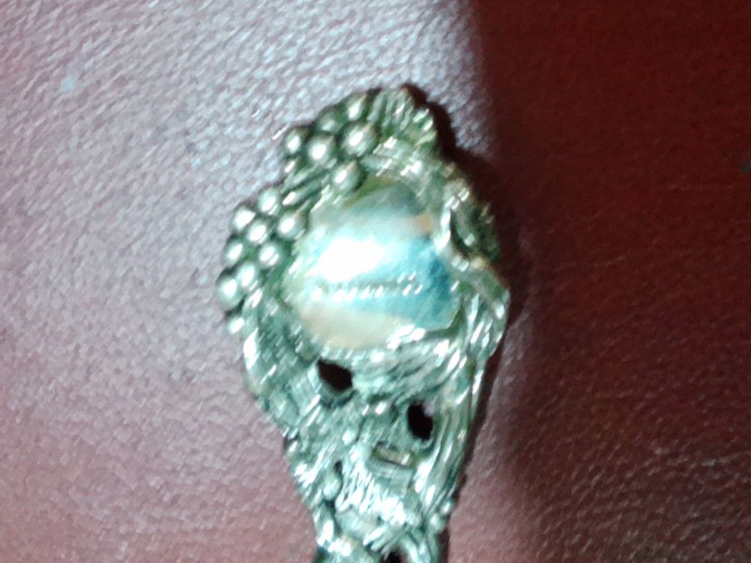 Decorative vintage silver plated spoon with ornate handle (Category: Dinnerware & Cutlery) located in Davao. Submitted by bravemoon_556cd5 (Listing ID 1465241806, Image 2). Description: - Vintage silver spoon with intricate grape and vine handle design - Solid metal construction with natural patina and tarnish from age - Smooth and reflective bowl surface - Palm-sized, approx. standard spoon length - Perfect decorative piece or addition to a vint