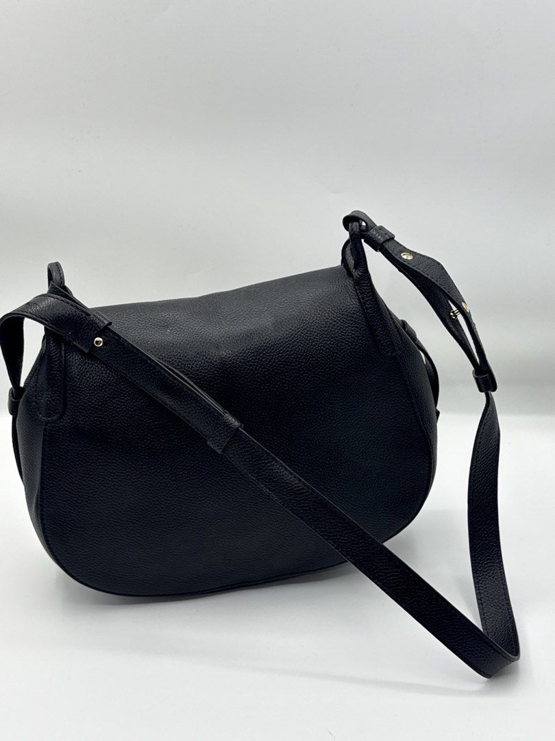 DeMellier Black Leather Shoulder Bag (Category: Shoulder Bags) located in Caloocan City. Submitted by rossvault2 (Listing ID 1465229897, Image 2). Description: - Authentic DeMellier shoulder/crossbody bag - Premium black textured grained leather with gold-tone hardware - Rectangular front lock closure and subtle logo embossing at the base - Adjustable shoulder strap detailed with stylish gold studs - Note: Strap features a discreet custom monogra