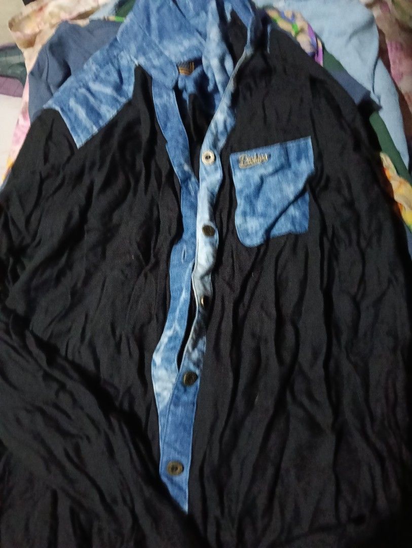 Dickies Black And Blue Denim Accent Button Up Shirt (Category: Tshirts & Polo Shirts ) located in Manila. Submitted by rakelherms (Listing ID 1465310907, Image 1). Description: - Brand: Dickies - Design: Solid black with blue acid wash denim panels on shoulders, collar, and front placket - Details: Single chest pocket with embroidered gold brand logo lettering - Closure: Button-down front with metallic buttons - Fabric: Comfortable lightweight ma