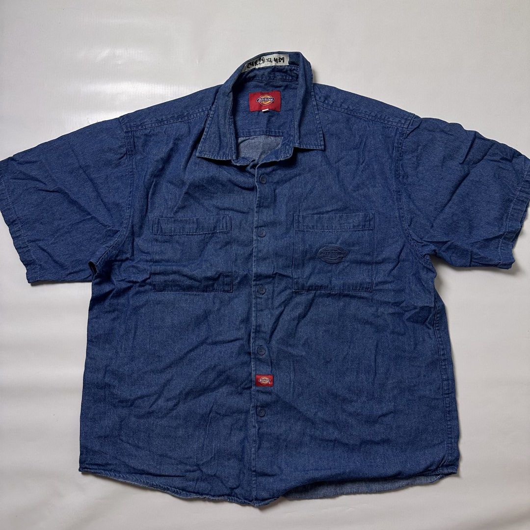 Dickies denim short sleeve button up shirt (Category: Tshirts & Polo Shirts ) located in Manila. Submitted by johnedel_james (Listing ID 1465281535, Image 1). Description: - Brand: Dickies - Color: Classic Blue - Material: Durable Denim - Style: Short sleeve, button-down front - Details: Dual chest pockets, branded buttons, embroidered logo on pocket, and red logo tab near hem - Condition: Excellent / Pre-loved - Origin: Made in China - Perfect c