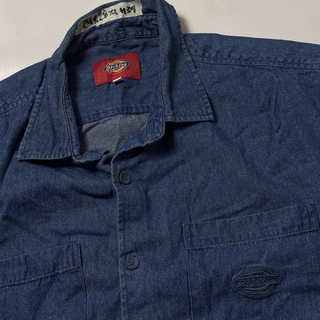 Dickies denim short sleeve button up shirt (Category: Tshirts & Polo Shirts ) located in Manila. Submitted by johnedel_james (Listing ID 1465281535, Image 2). Description: - Brand: Dickies - Color: Classic Blue - Material: Durable Denim - Style: Short sleeve, button-down front - Details: Dual chest pockets, branded buttons, embroidered logo on pocket, and red logo tab near hem - Condition: Excellent / Pre-loved - Origin: Made in China - Perfect c