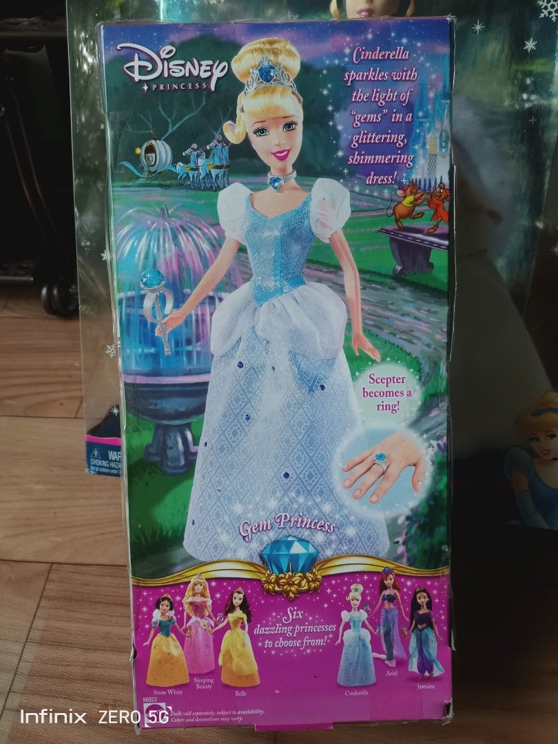 Disney Princess Gem Princess Cinderella Doll (Category: Kids Toys) located in Naga. Submitted by cosmicrabbit.09254a (Listing ID 1465209877, Image 3). Description: - Authentic Disney Princess Cinderella doll from the Gem Princess collection - Wears her iconic blue glittery ballgown with matching tiara and choker - Includes a special scepter that transforms into a wearable ring - Brand new, stored securely inside the original cardboard and plastic