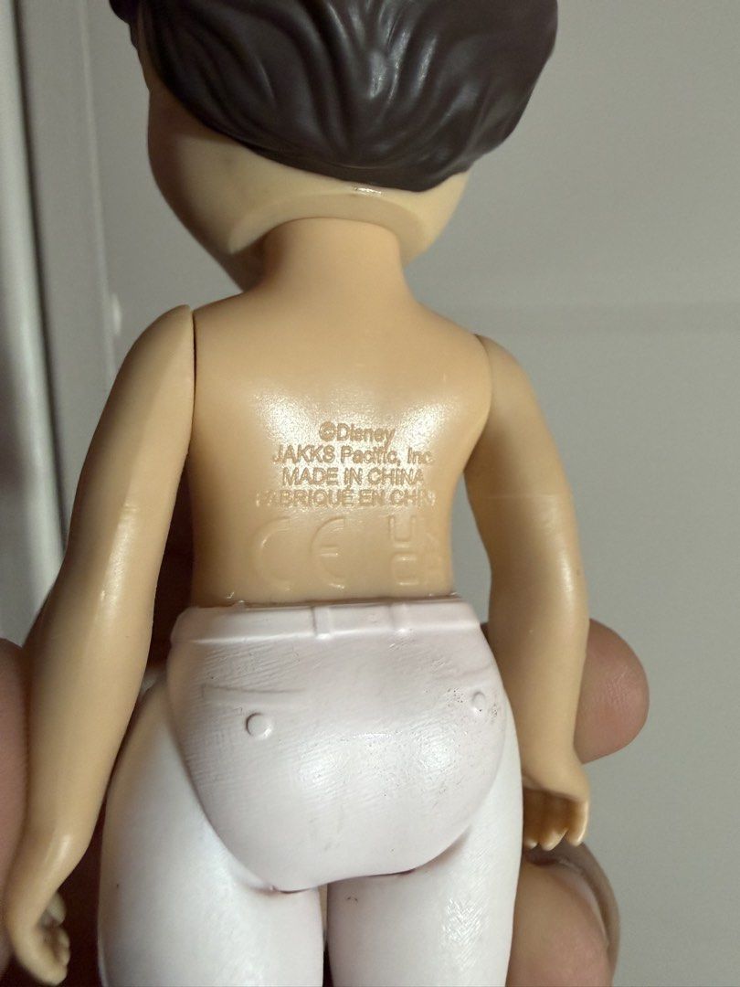 Disney’s Prince Eric Doll (Category: Figurines & Statues) located in Plaridel. Submitted by moddedjarvis (Listing ID 1465172219, Image 3). Description: - Brand/Maker: Disney by JAKKS Pacific - Appearance: Molded short brown hair, blue eyes, shirtless body - Outfit: Includes white pants and black boots with red trim (original shirt missing) - Condition: Loose figure, clean plastic limbs, and decent face paint - Authenticity: Back stamp includes Di