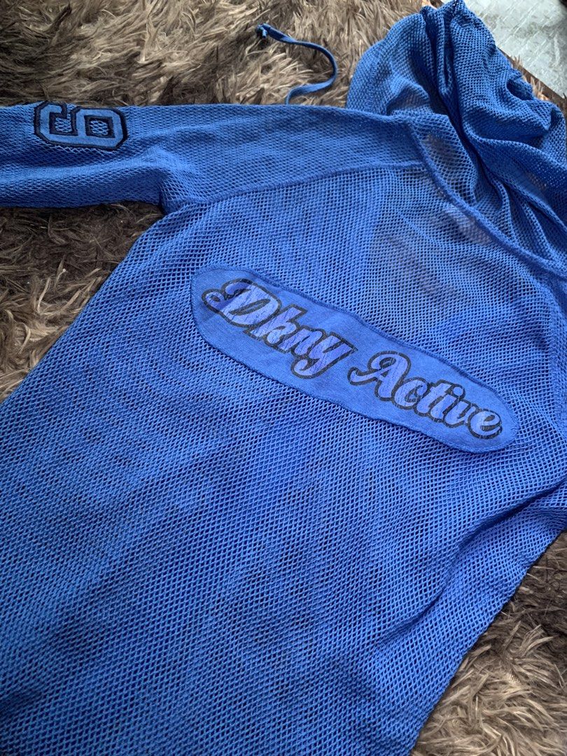DKNY Active Blue Mesh Zip-Up Hoodie (Category: Coats, Jackets and Outerwear) located in Cebu City. Submitted by selamethrift (Listing ID 1465264701, Image 3). Description: - Brand: DKNY Active - Color: Bright blue - Size: Medium - Material: Nylon and Spandex (Made in Korea) - Fabric: Lightweight open mesh - Features: Full front zip, hood with adjustable drawstrings, long sleeves - Details: Number '8' applique patch on left sleeve and large 'DKNY 