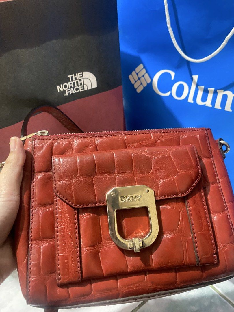 DKNY Red Croc Embossed Crossbody Bag (Category: Cross-body Bags) located in San Narciso. Submitted by boypablo1998 (Listing ID 1465294276, Image 1). Description: - Brand: DKNY - Material: Croc-embossed leather in a bold red shade - Closure: Secure zippered top closure - Hardware: Eye-catching gold-tone DKNY clasp on the front flap pocket - Size: Compact, ideal for carrying everyday essentials - Design: Stylish crossbody with side-attached straps.