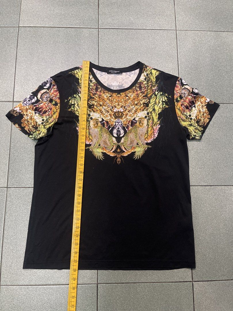 Dolce & Gabbana Monkey Print Graphic T-Shirt (Category: Tshirts & Polo Shirts ) located in Manila. Submitted by dailygetup (Listing ID 1465327596, Image 2). Description: - Brand: Dolce & Gabbana - Color: Black base with intricate jungle animal graphics - Special Features: Crystal embellishments on the monkeys and unique patterned sleeves - Origin: Made in Italy tag at the collar - Measurements (laid flat): Width approx. 21" across chest, Length a
