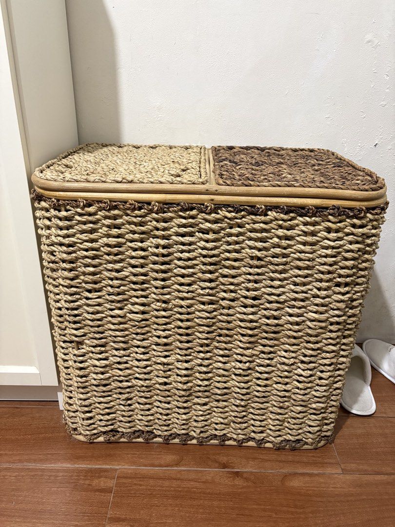 Double compartment woven laundry hamper with lids. with linen lining (Category: Laundry Baskets) located in Paranaque City. Submitted by joansy123 (Listing ID 1465335255, Image 1). Description: - Material: Woven water hyacinth or seagrass with a sturdy bamboo/rattan frame - Design: Two separate compartments with individual hinged lids for easy sorting - Aesthetic: Natural beige and dark brown two-tone finish, perfect for bedrooms or bathrooms - C