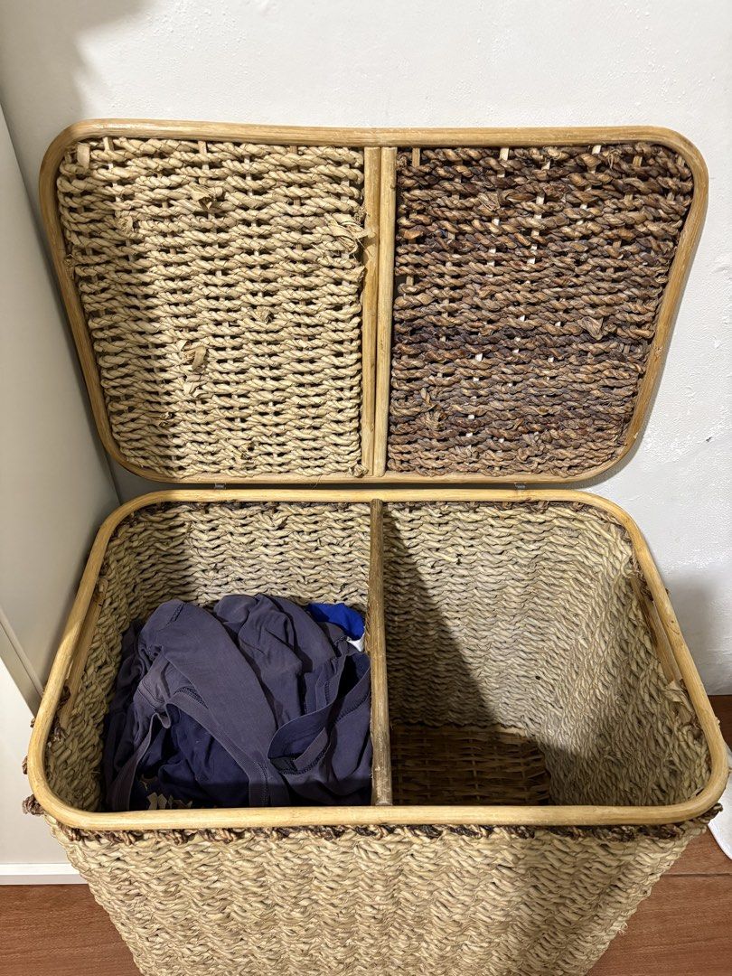 Double compartment woven laundry hamper with lids. with linen lining (Category: Laundry Baskets) located in Paranaque City. Submitted by joansy123 (Listing ID 1465335255, Image 3). Description: - Material: Woven water hyacinth or seagrass with a sturdy bamboo/rattan frame - Design: Two separate compartments with individual hinged lids for easy sorting - Aesthetic: Natural beige and dark brown two-tone finish, perfect for bedrooms or bathrooms - C