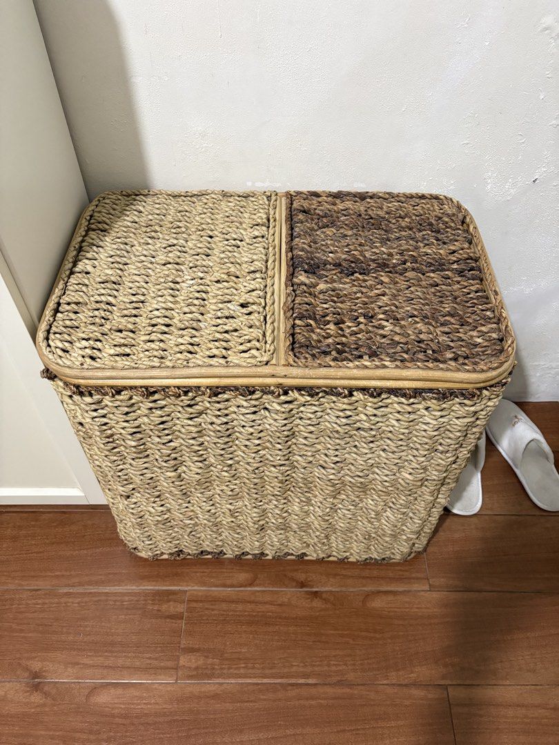 Double compartment woven laundry hamper with lids. with linen lining (Category: Laundry Baskets) located in Paranaque City. Submitted by joansy123 (Listing ID 1465335255, Image 2). Description: - Material: Woven water hyacinth or seagrass with a sturdy bamboo/rattan frame - Design: Two separate compartments with individual hinged lids for easy sorting - Aesthetic: Natural beige and dark brown two-tone finish, perfect for bedrooms or bathrooms - C