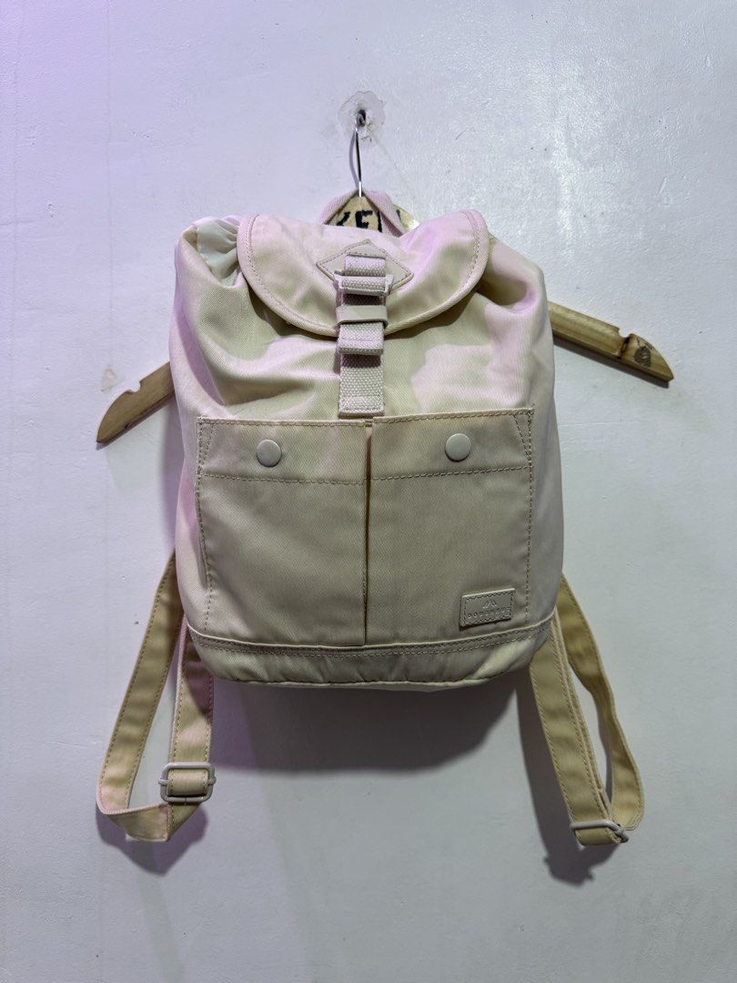 Doughnut beige mini backpack (Category: Backpacks) located in Manila. Submitted by esparciake75752 (Listing ID 1465305226, Image 2). Description: - Brand: Doughnut - Color: Beige - Closure: Drawstring under main flap with front snap pockets - Straps: Adjustable shoulder straps and convenient top carry handle - Condition: Clean fabric exterior with signature brand patch - Usage: Compact size, ideal for daily commutes or quick trips.